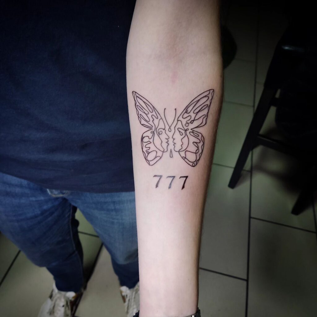 Creative Outline Butterfly with 777 Below on the Forearm: Butterfly Whimsy 