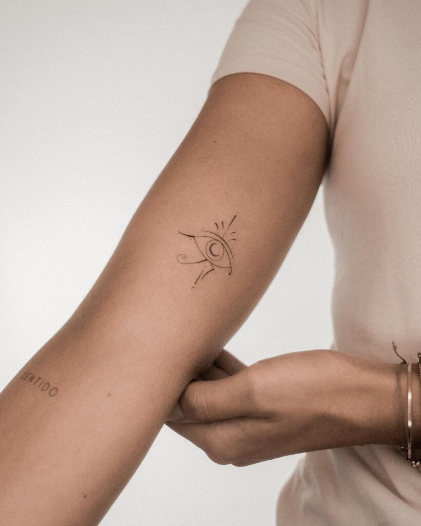 Creative outline eyeball tattoo on bicep an artistic touch for females