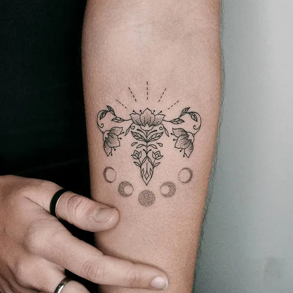 Crescent moon womb tattoo