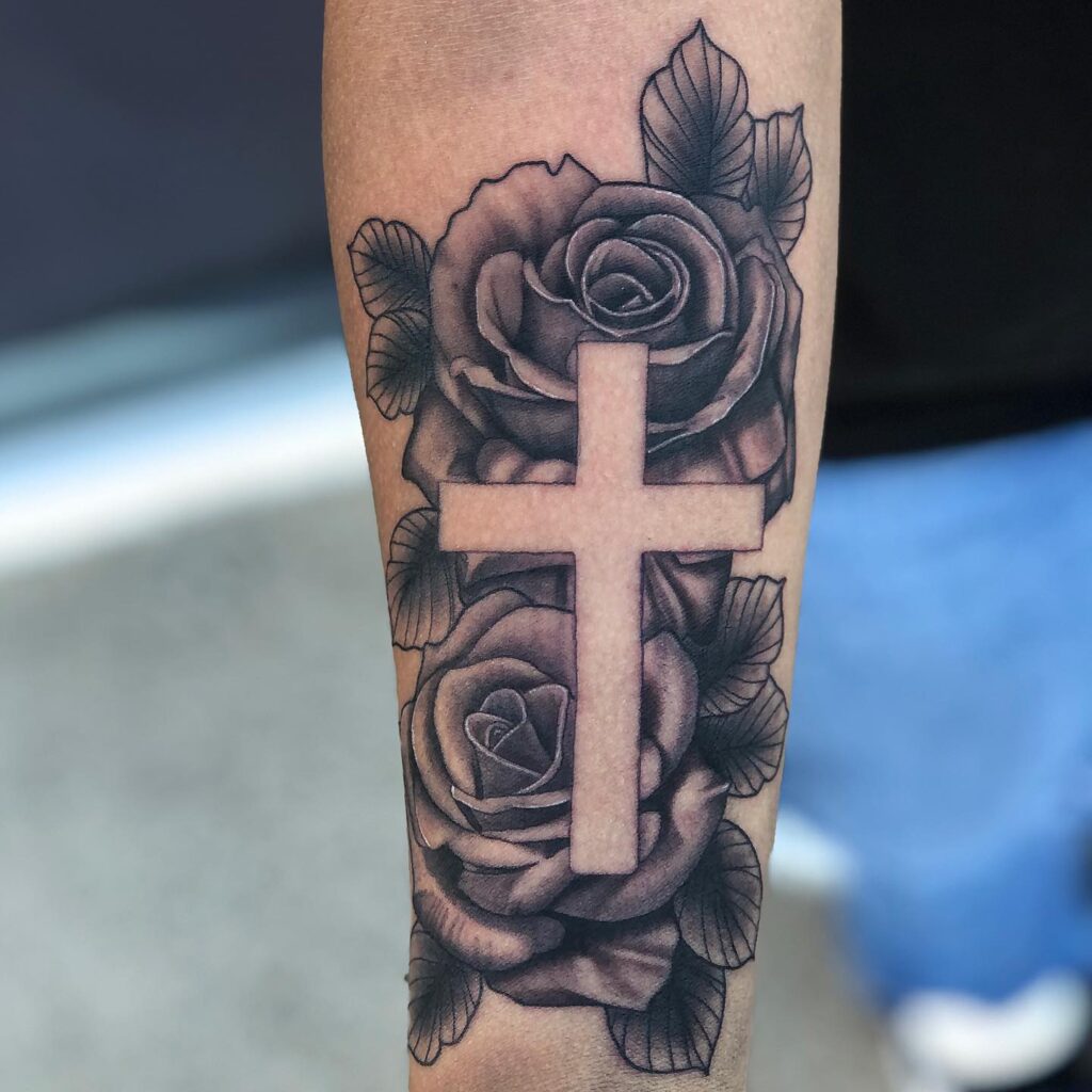 Cross above the wrist with roses on the inner wrist a subtle and elegant symbol of faith