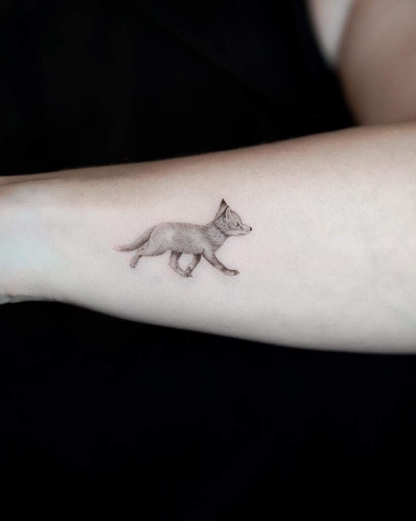 Cute Baby Fox Walking on the Side of the Forearm in Black and Grey: Tiny Wanderer
