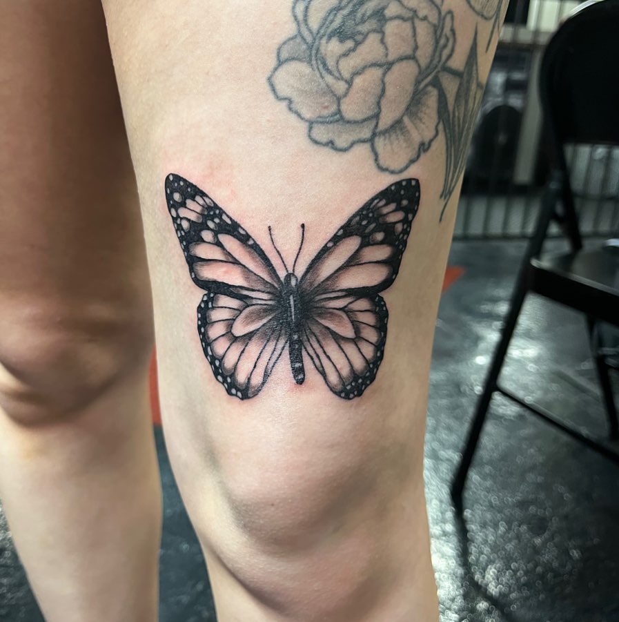 Cute butterfly above knee tattoo designs image