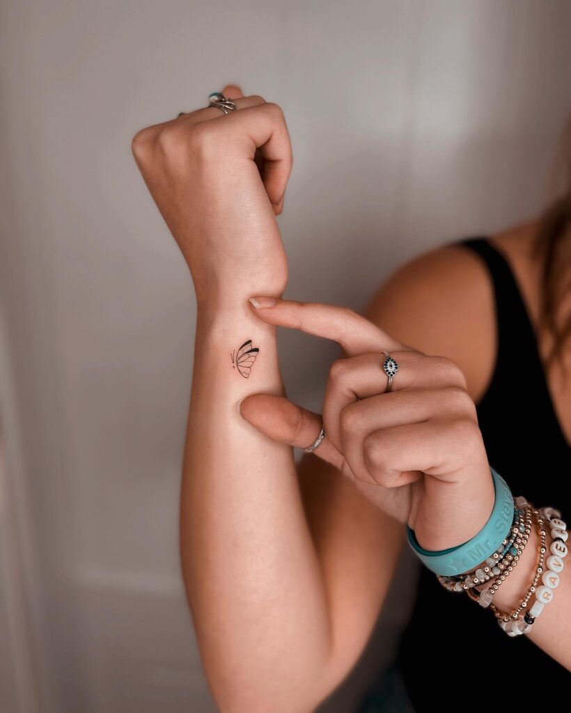 Cute Butterfly Semicolon Tattoo on the Side of the Wrist: Fluttering Elegance