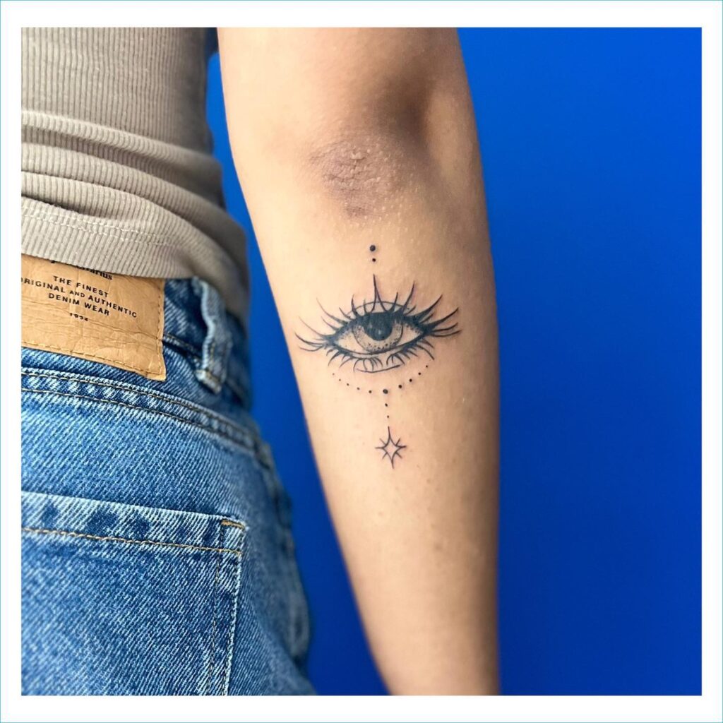 Cute eye tattoo on outer arm a delicate choice below the elbow