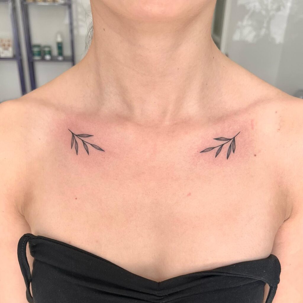 Cute little 'gałązki' tattoo on the collarbone, a subtle branching accent nature's whisper