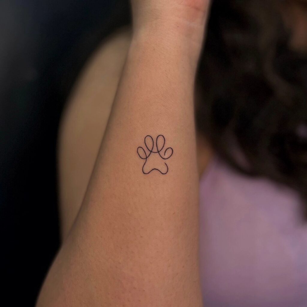 Cute One-Line Paw Tattoo on the Side of the Wrist: Wrist Simplicity