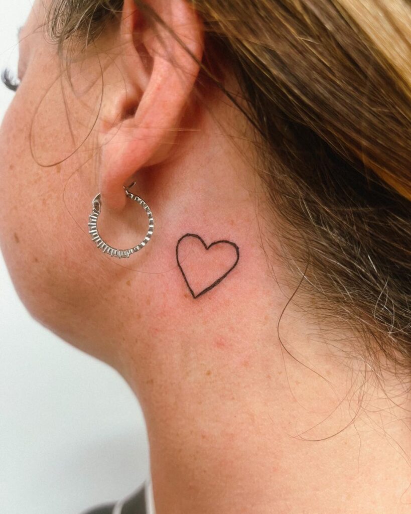 Cute outline heart tattoo behind the ear elegance