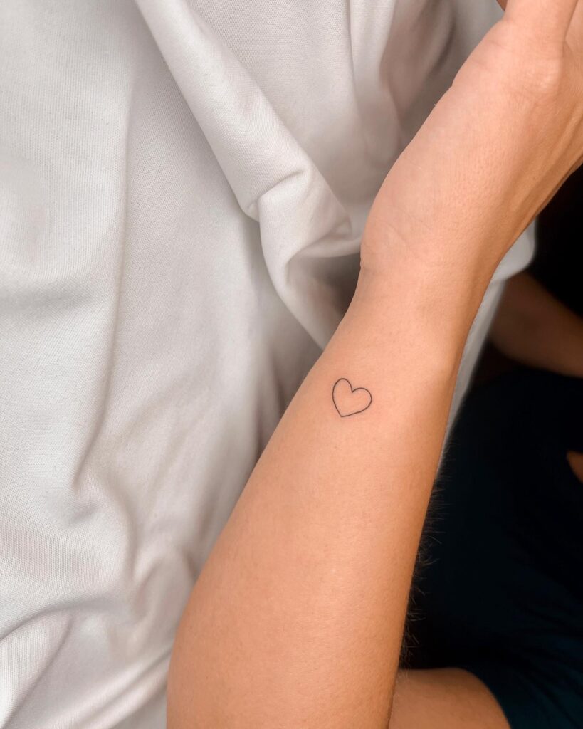 Cute outline heart tattoo on the side of the wrist wrist whispers