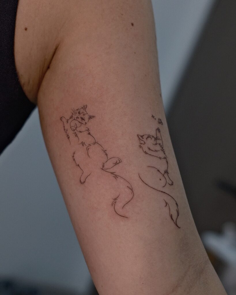 Cute playful cats fine line tattoo with sparkles whimsical style