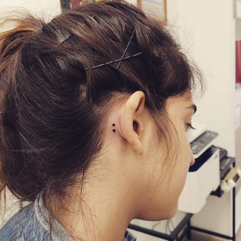 Cute Semicolon Tattoo Behind the Ear: Delicate Ear Adornment