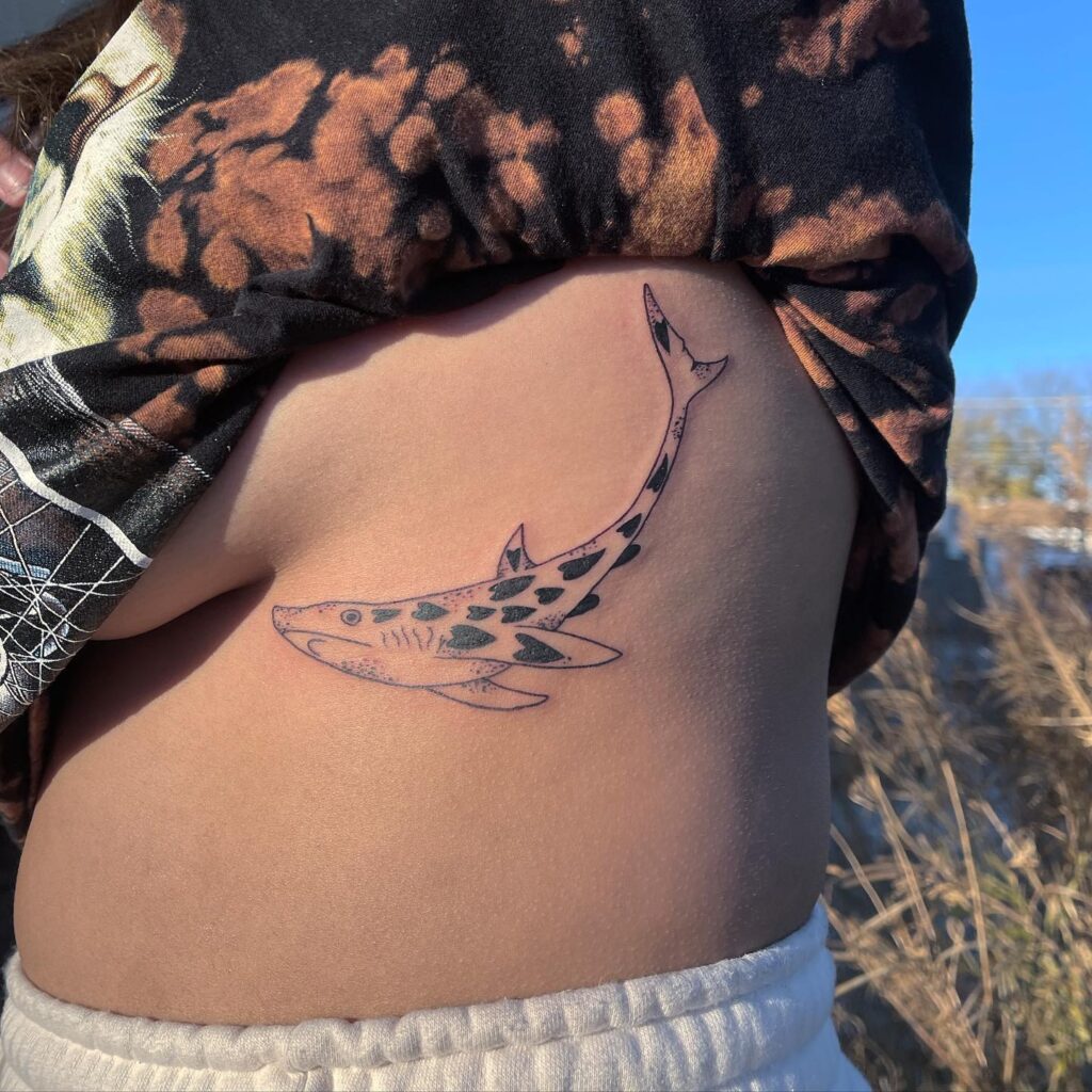 Cute shark tattoo on the rib for women with artistic pattern ocean's grace