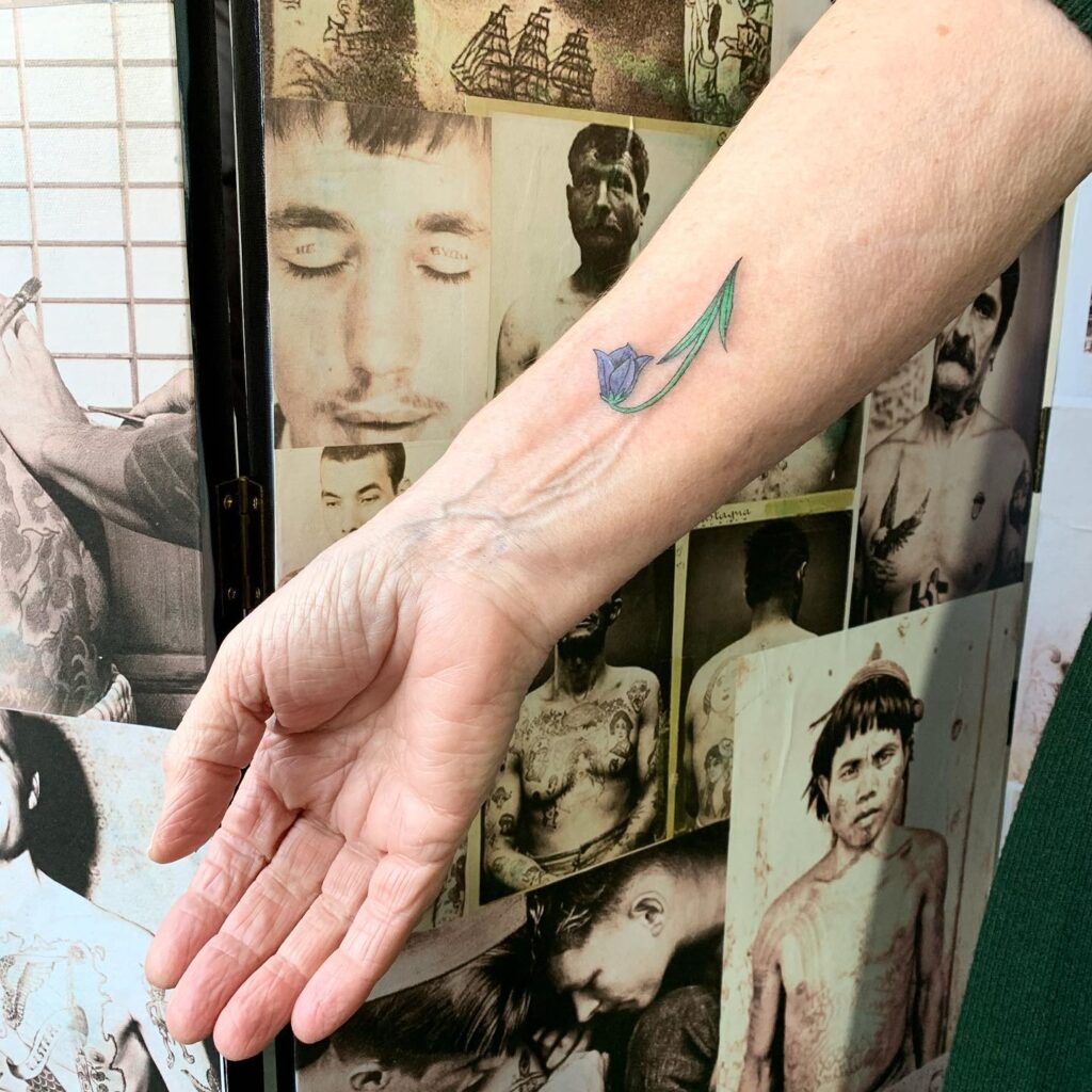 Cute Single Bluebell Tattoo on the Forearm: Solo Beauty