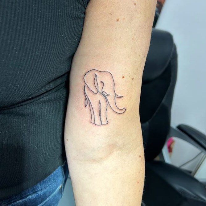 Cute small outline front view elephant tattoo: minimalist delight