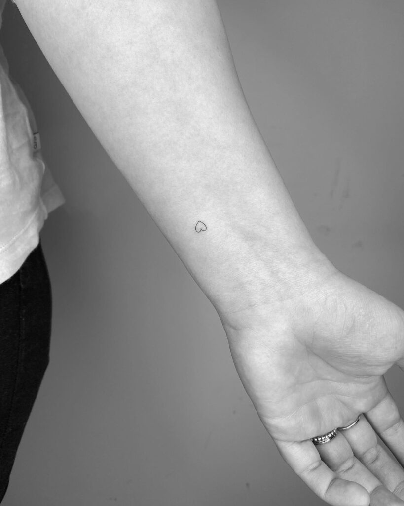 Cute tiny heart outline tattoo on the inner wrist whispers of love