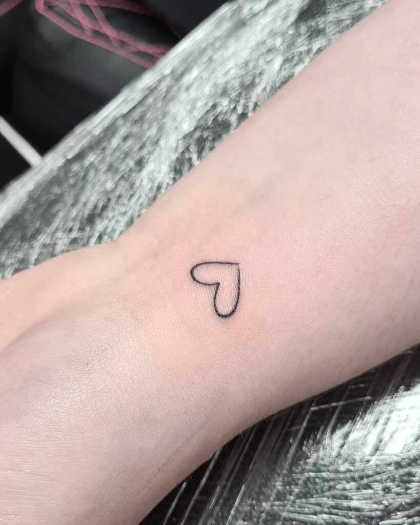Cutest little heart outline black tattoo on wrist