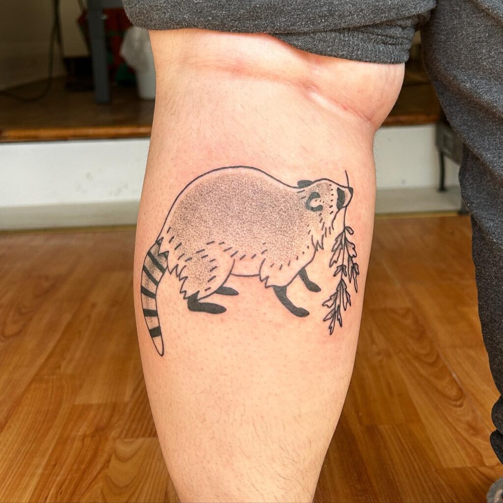 Cutie Raccoon with a Branch Tattoo on the Calf - Playful and Endearing: Raccoon Whimsy 