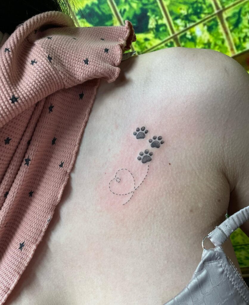 Dainty Trio of Dog Paws and Heart Outline Tattoo: Collarbone Canine Trio