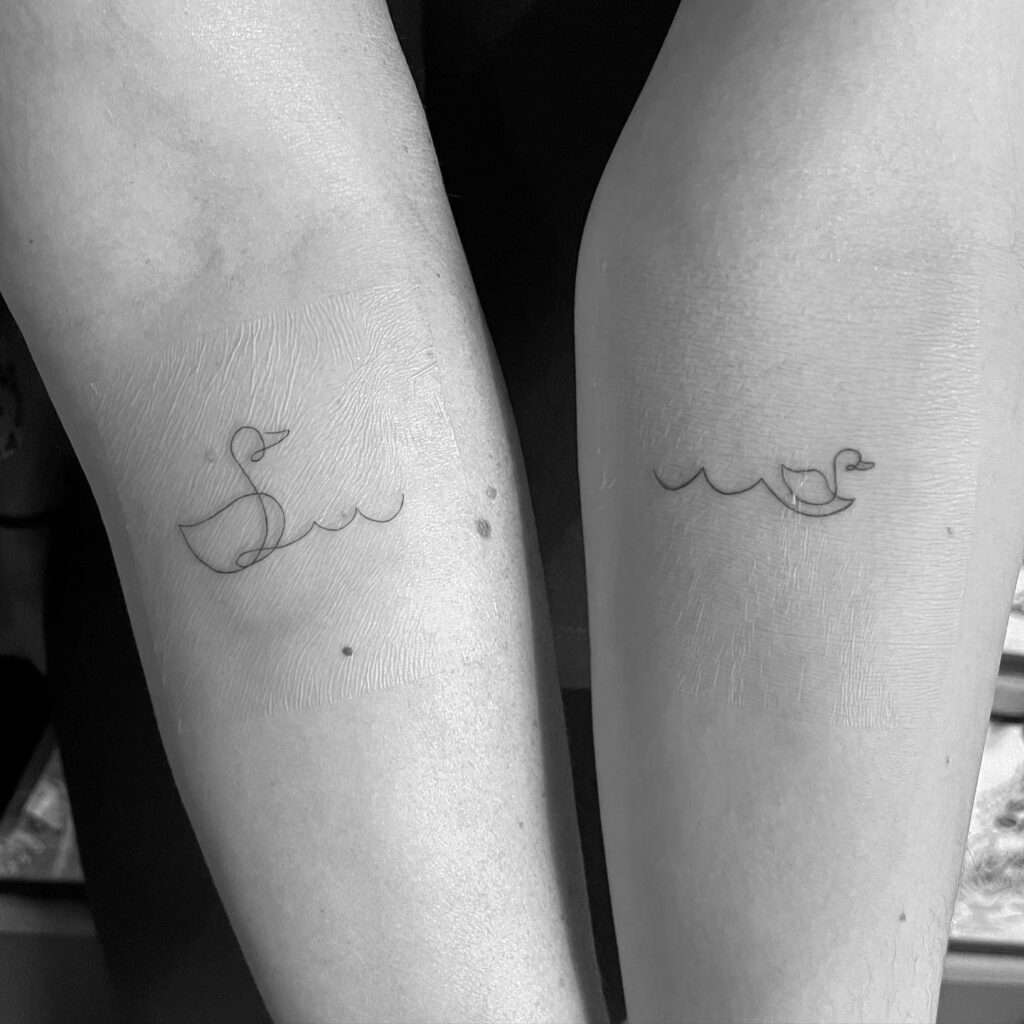 Delicate Swan and Waves Mother Daughter Tattoo on their Forearms
