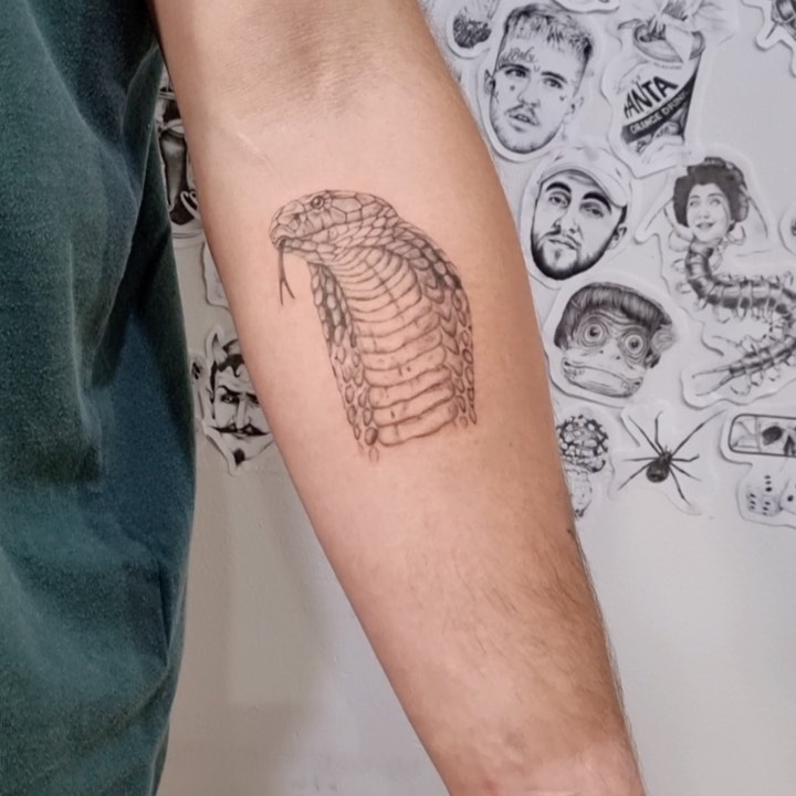 Dark and delicate cobra tattoo simple serpent head on forearm