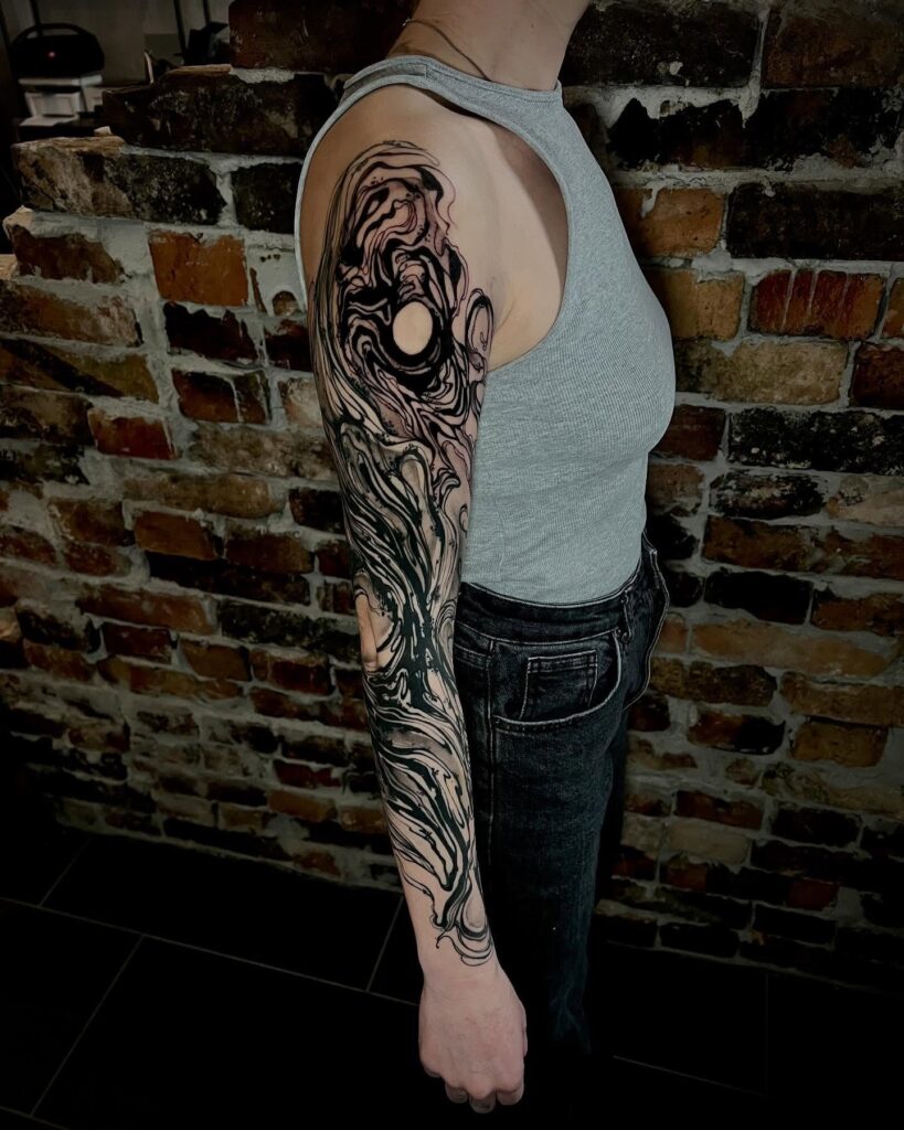 Dark gothic Grim Reaper sleeve tattoo with red highlights