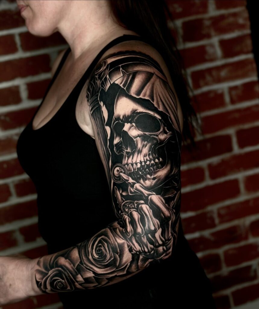 Dark gothic tattoo sleeve with a grim reaper, hourglass, and high-contrast shading