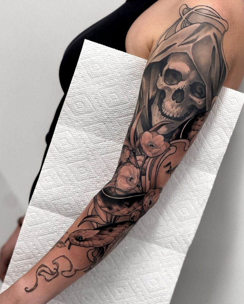 Dark gothic tattoo sleeve with grim reaper and floral contrast