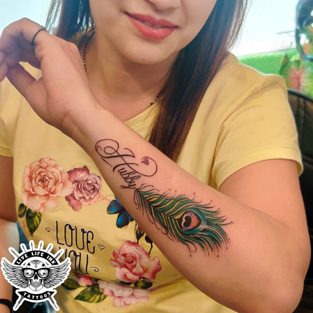 Dedicated hubby text with beautiful peacock feather an outer forearm masterpiece