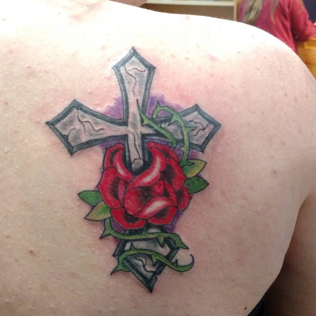 Delicate and Feminine Cross with Rose Tattoo on the Back of the Shoulder
