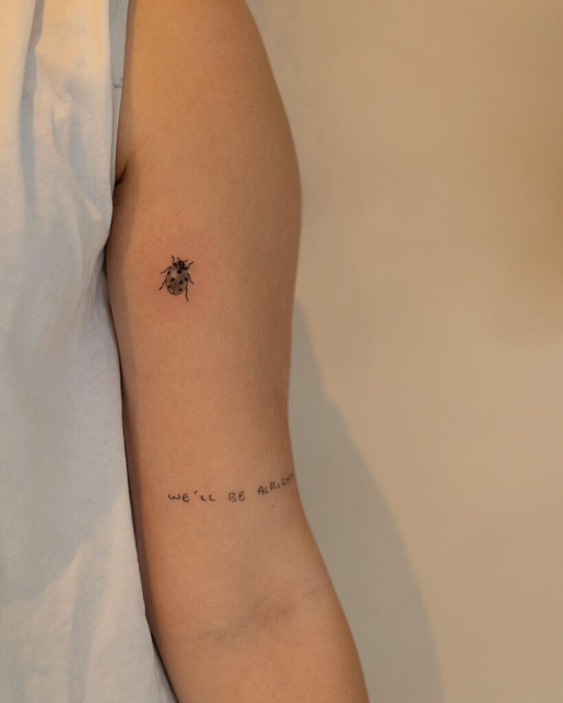 Delicate and meaningful inner arm ladybug tattoo on arm for females