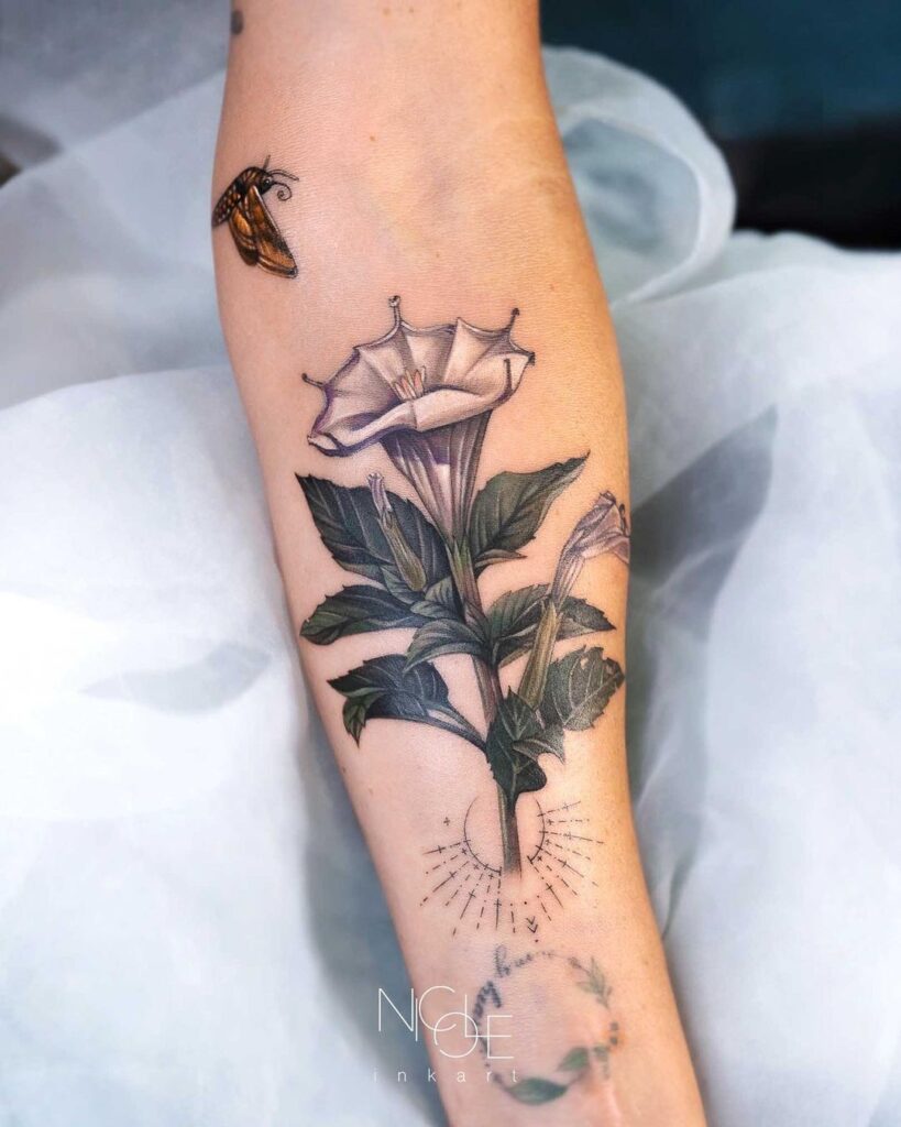 Delicate botanical magic datura flower and moth calf tattoo 