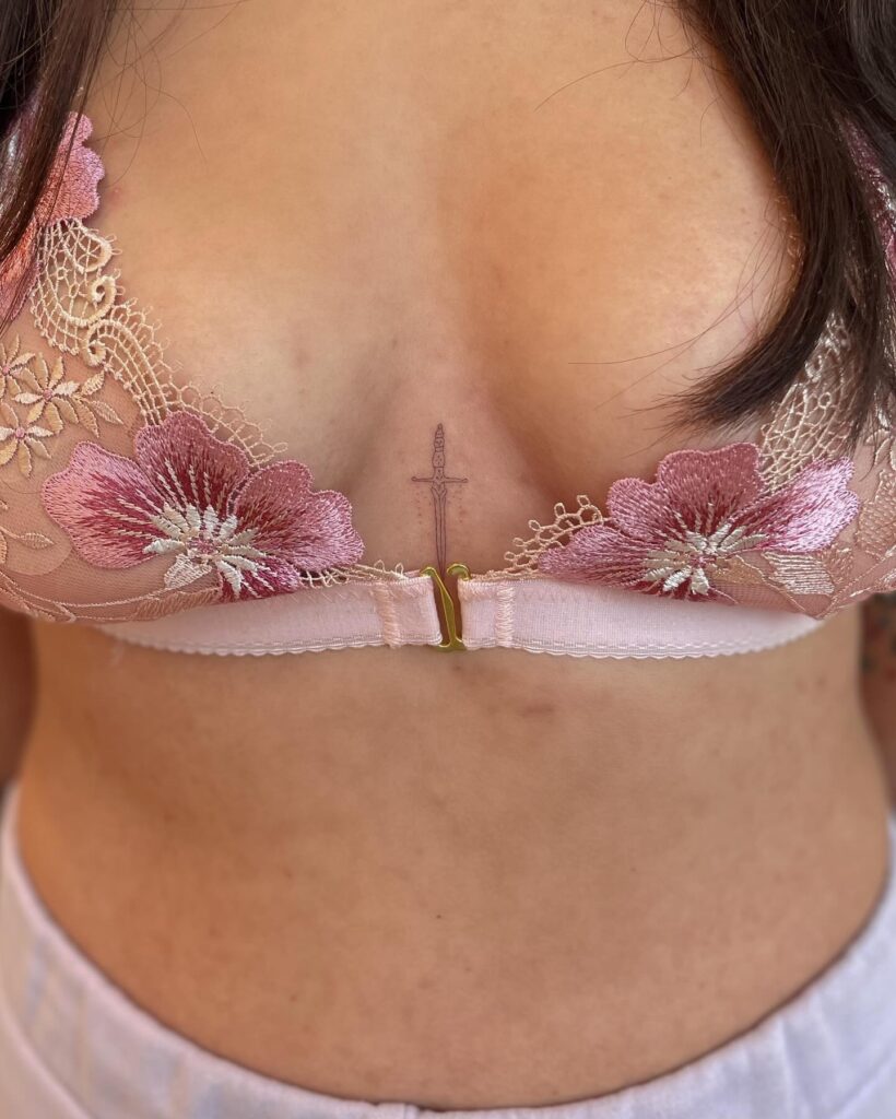 Delicate Chest Tattoo, a Small Feminine Accent: Intricate Dagger Delight