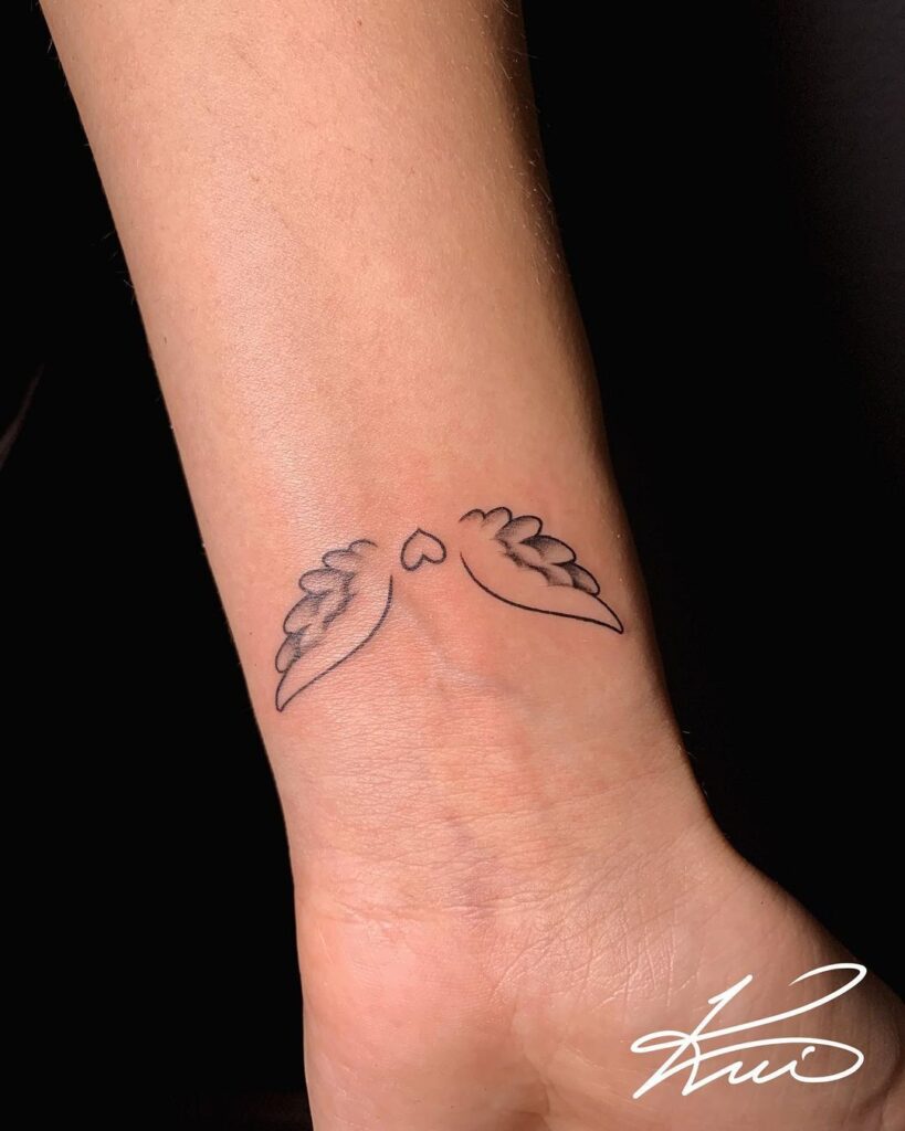 Delicate choice cute small fineline angel wings arm tattoo with heart outline
