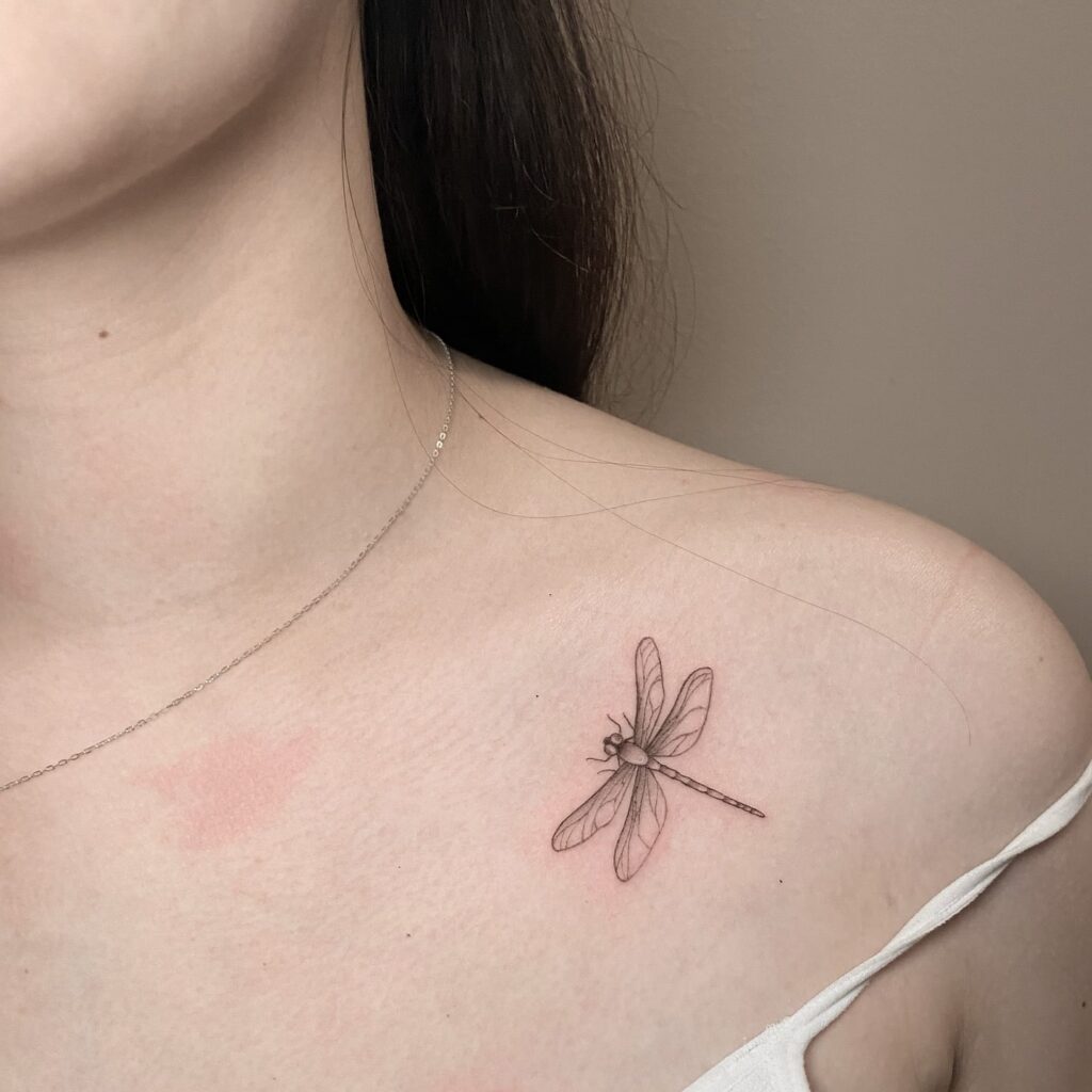 Delicate Collarbone Dragonfly Tattoo Representing Change and Freedom