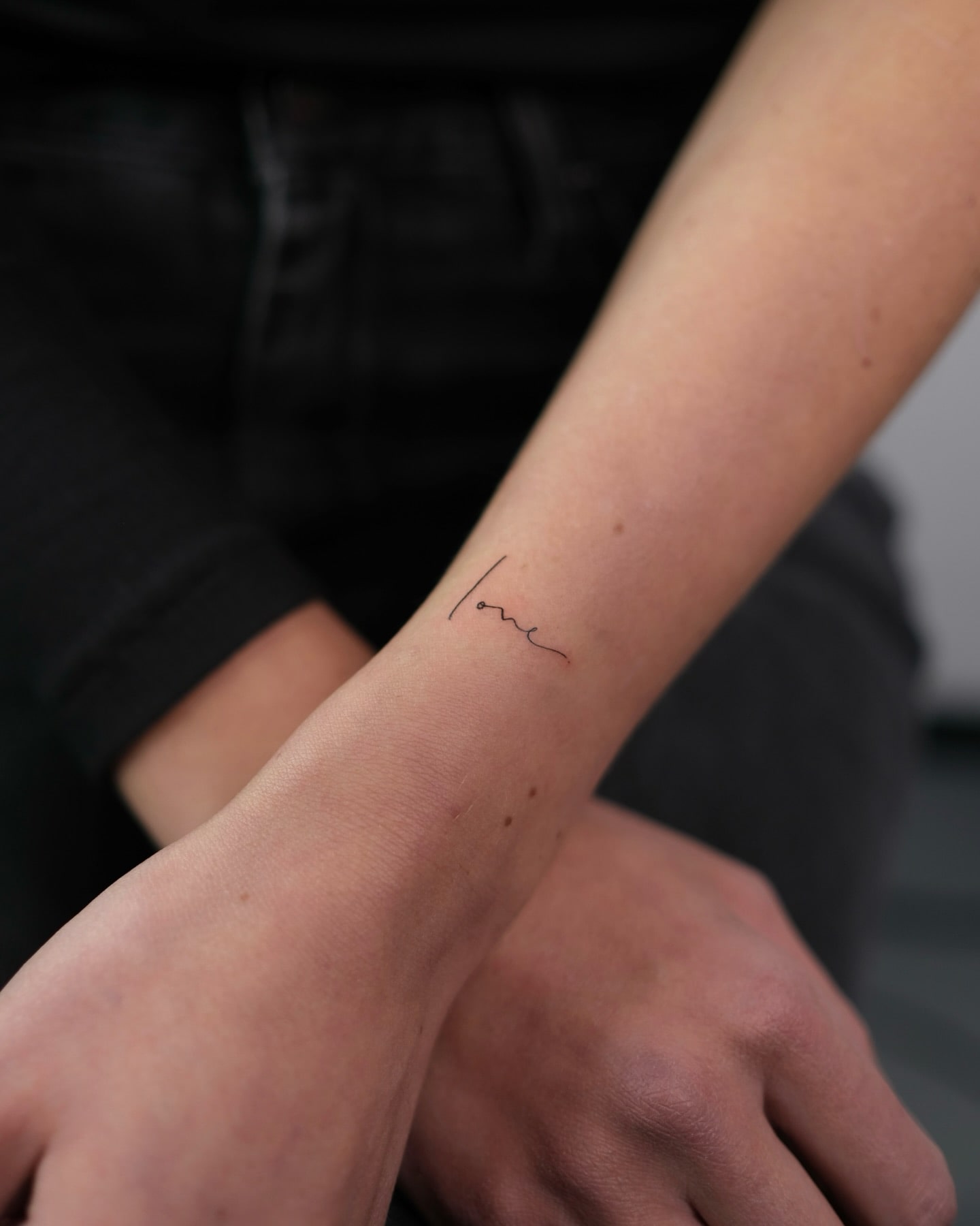 Delicate Cursive Love Tattoo Minimalist and Elegant Wrist Design
