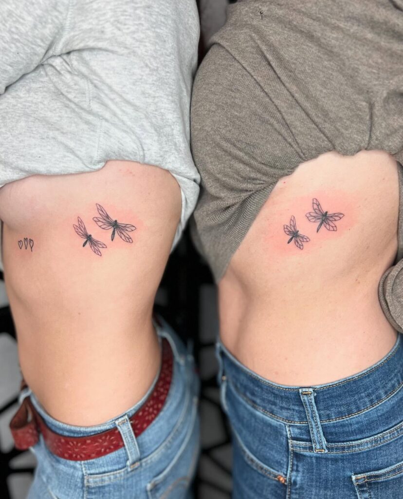 Delicate dragonfly rib tattoos symbolizing mother-daughter transformation