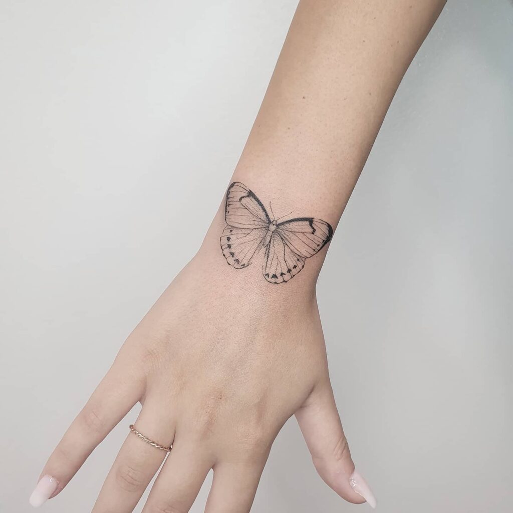 Delicate fineline tattoo on the outer wrist for girls, bringing a subtle and artistic flair: whimsical lines