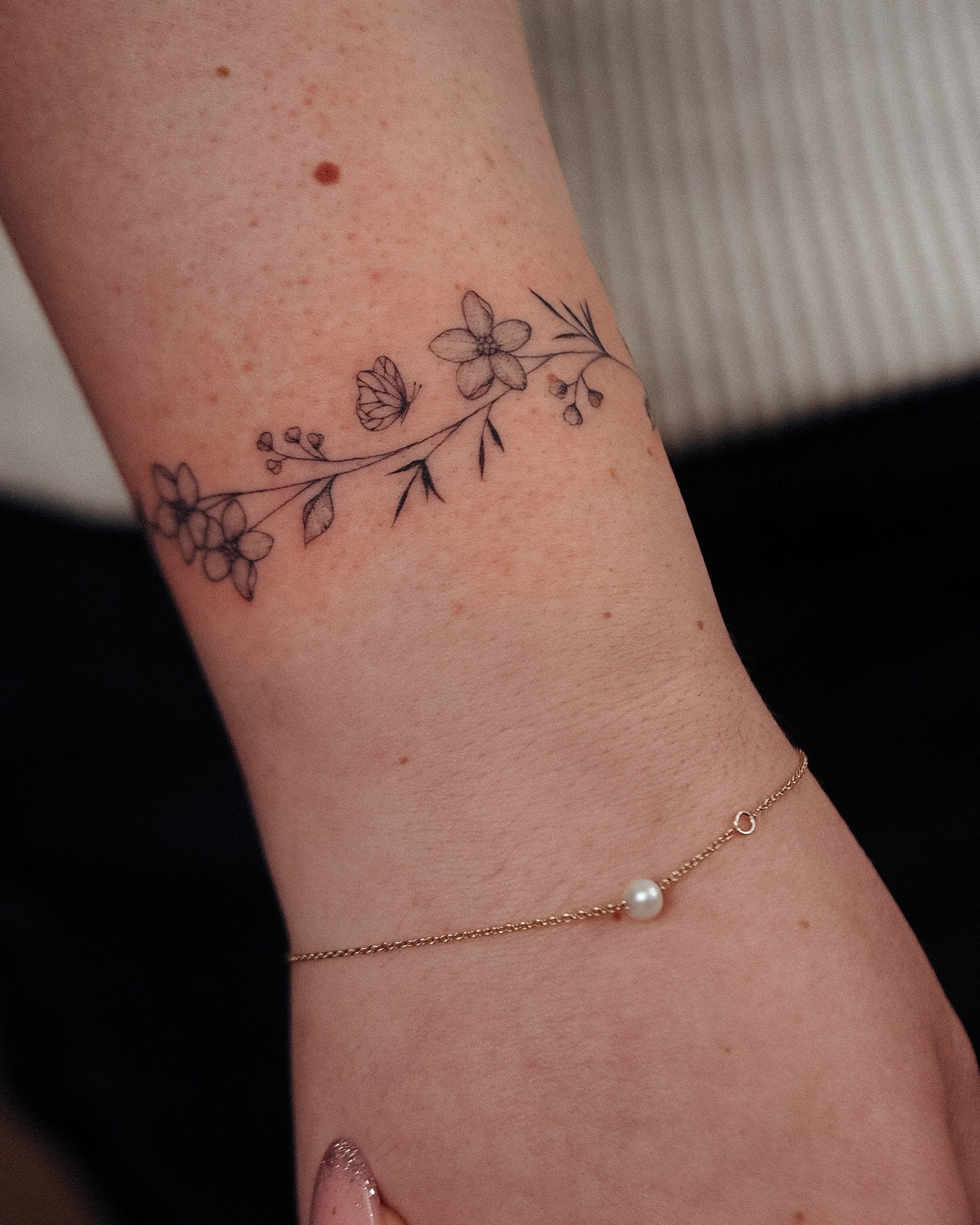 Delicate Floral Wristband Tattoo with Butterfly Elegant and Nature-Inspired