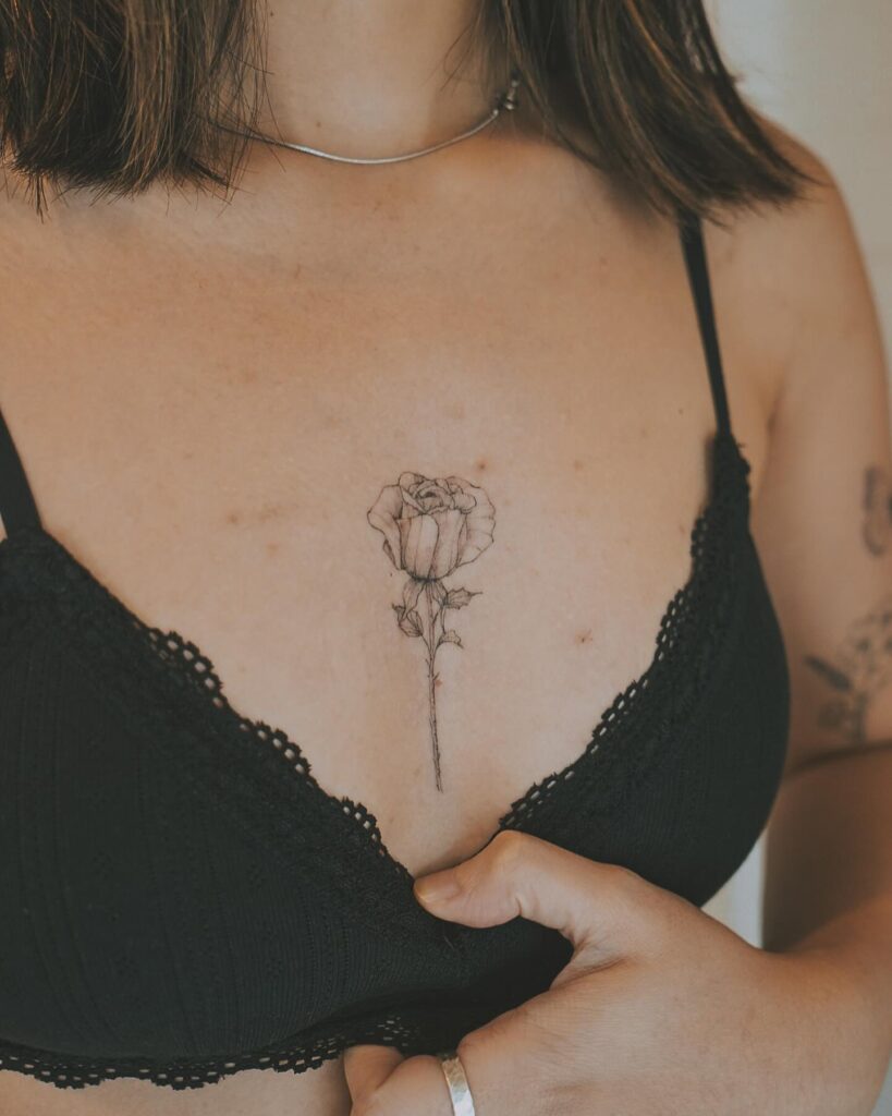 Delicate rose sternum tattoo with fine-line shading for a feminine touch