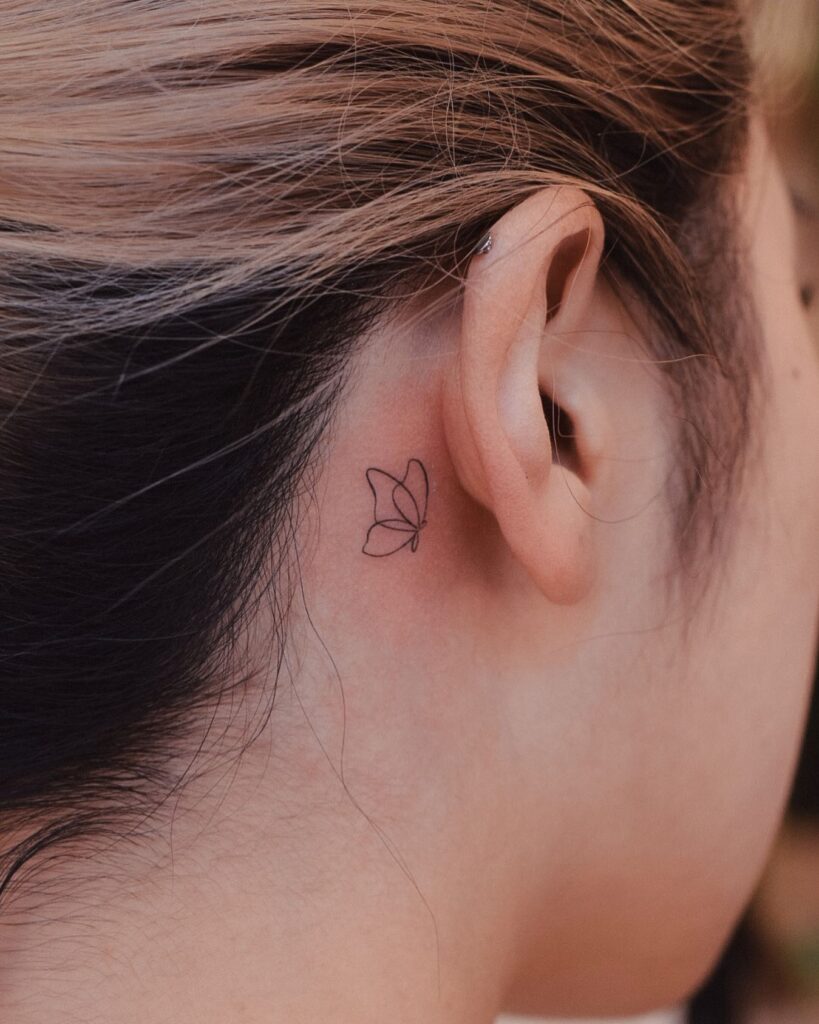 Delicate tiny butterfly tattoo a minimalist touch behind the ear ear whispers