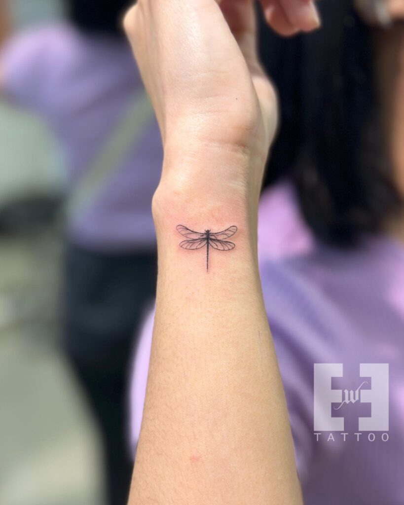 Delicate Wrist Dragonfly Tattoo with Fine-Line Elegance