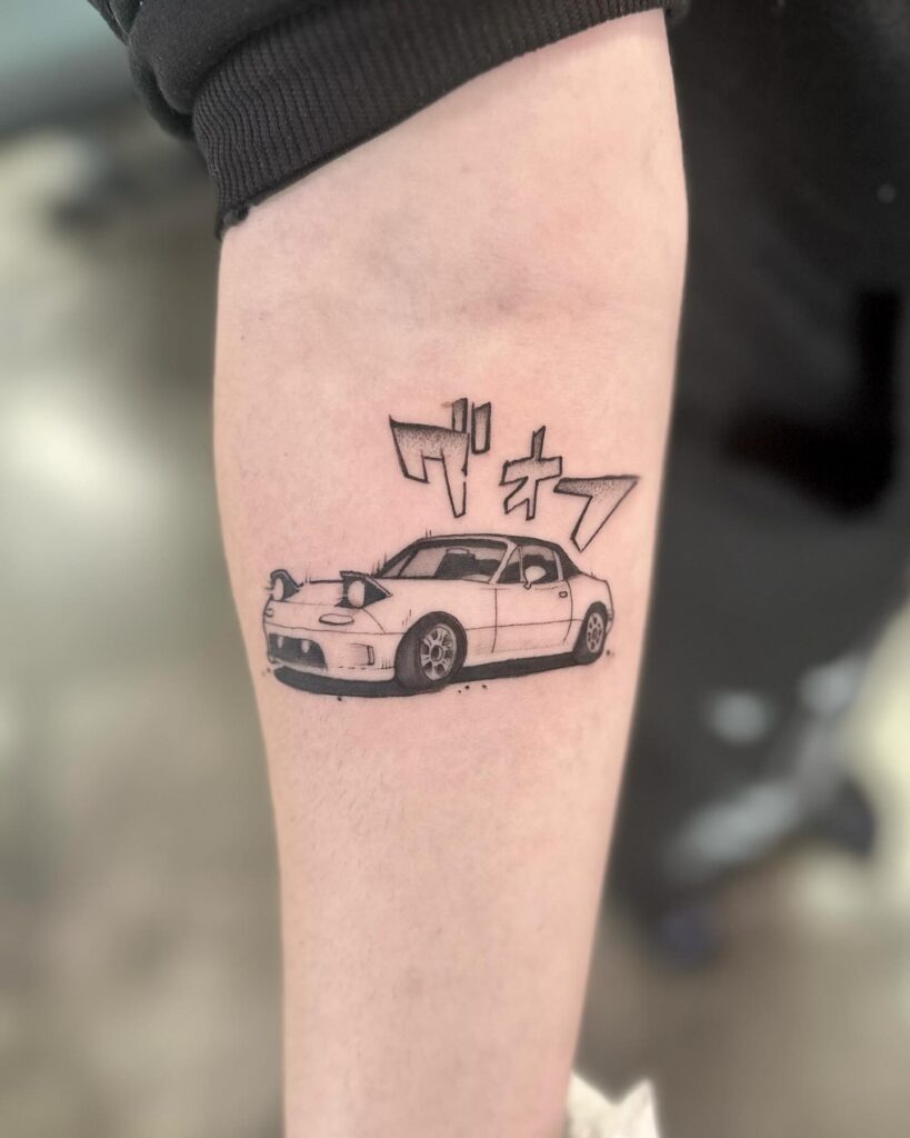 Detailed Black and White Mazda MX-5 Miata Tattoo with Japanese Katakana on Forearm – Car Tattoo Ideas