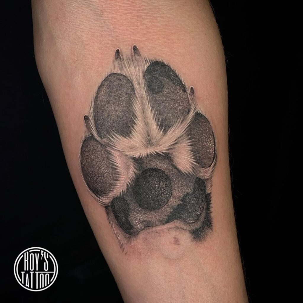 Detailed realism black and grey paw print forearm tattoo for men