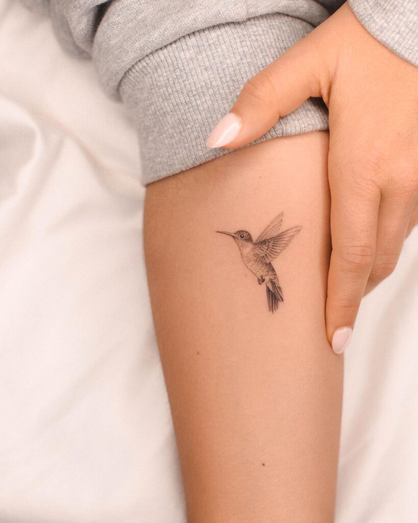 Detailed small hummingbird tattoo on the inner forearm humming harmony