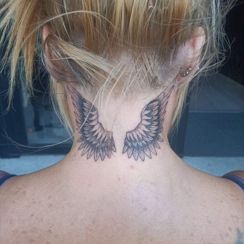 Detailed Wings Tattoo on the Back of the Neck: Intricate Lift