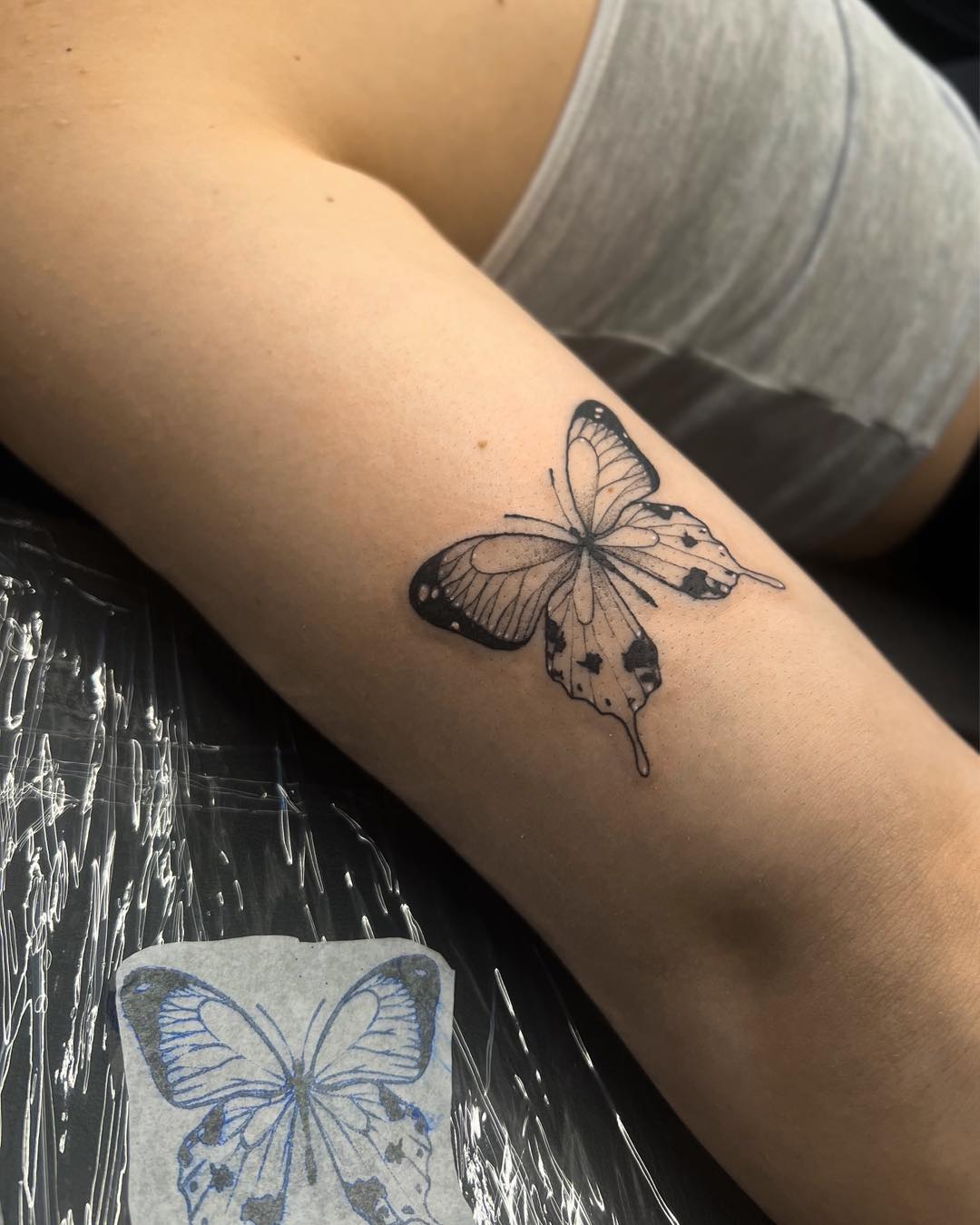 Distressed butterfly tattoo with torn wing effect and emotional depth