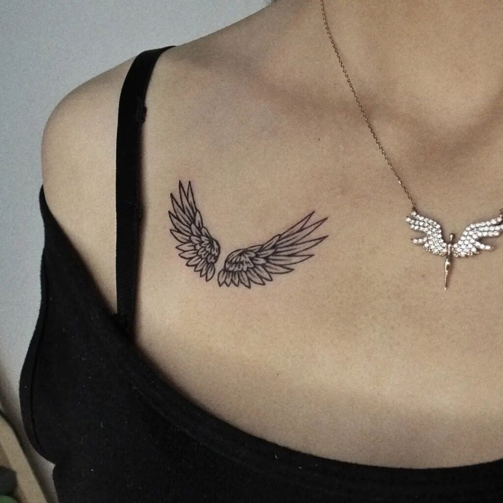 Divine adornment angel wings tattoo on the collarbone