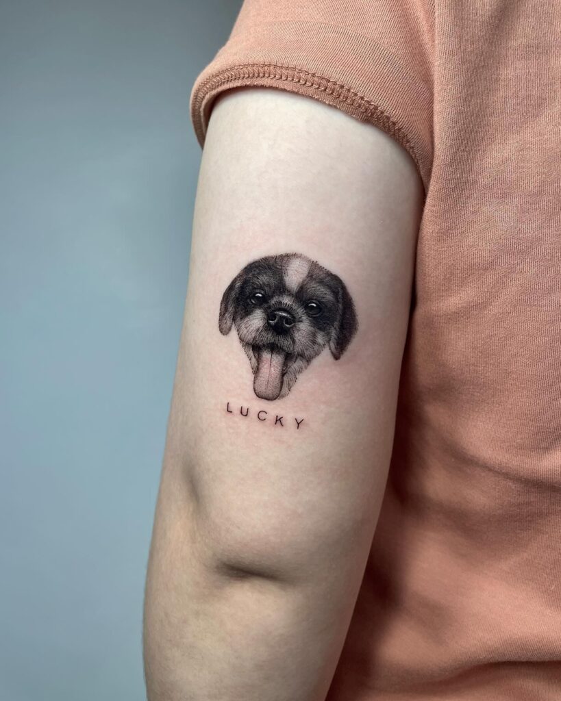 Dog Head Tattoo with 'Lucky' Lettering Above the Elbow for a Playful Touch: Lucky Paws