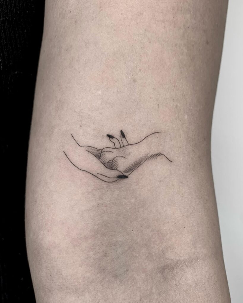 Dog Paw and Human Hand Tattoo on the Above the Elbow: Paw Prints of Bond