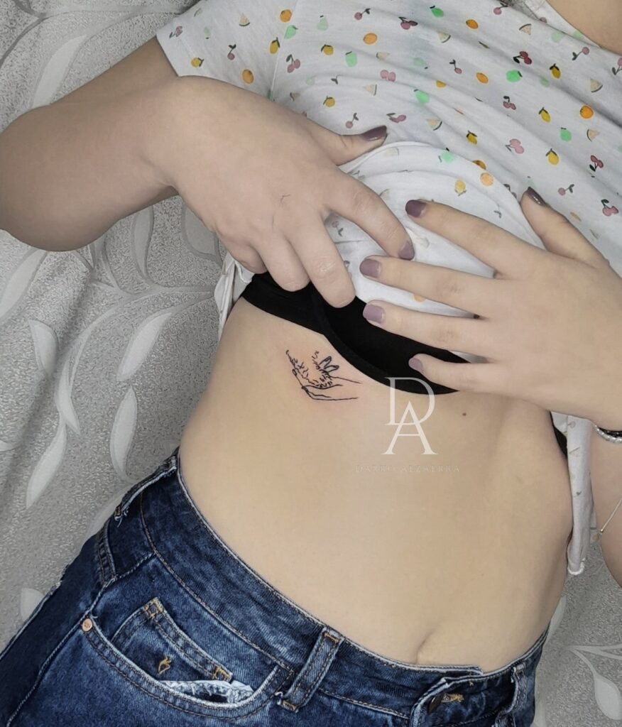 Dog Paw and Human Hand Tattoo on the Rib for a Symbolic Touch: Paw & Hand Harmony