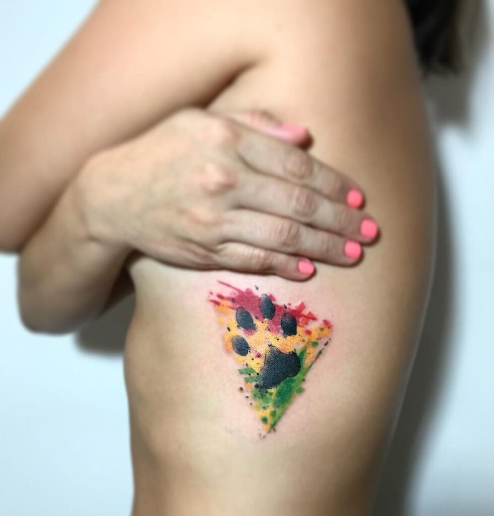 Dog Paw Print Tattoo with Watercolor Background on the Rib: Rib Rendezvous